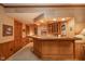 Basement bar area with wooden counter, built-in wine storage, and paneled walls at 206 Somerville Rd, Anderson, IN 46011