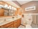 Bright bathroom with double sinks, and a large mirror and vanity with ample storage at 206 Somerville Rd, Anderson, IN 46011