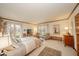 Bright bedroom with a large window, neutral colors, and cozy seating area at 206 Somerville Rd, Anderson, IN 46011