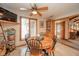 The eat-in dining area has a wood table, ceiling fan, and built-in bookcase at 206 Somerville Rd, Anderson, IN 46011