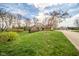Well maintained homes in quiet neighborhood; lush lawns and mature trees enhance curb appeal at 206 Somerville Rd, Anderson, IN 46011
