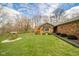 Charming brick home featuring a lush front lawn, mature trees, and well-manicured landscaping at 206 Somerville Rd, Anderson, IN 46011