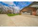 Side view of a brick home with a two car garage and a wide driveway at 206 Somerville Rd, Anderson, IN 46011