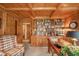 The home office has wood paneling, built-in shelving, and large windows for natural light at 206 Somerville Rd, Anderson, IN 46011