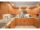 Updated kitchen with granite countertops, stainless appliances, and custom cabinets with ample storage at 206 Somerville Rd, Anderson, IN 46011