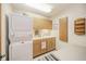 Functional laundry room with stacked washer/dryer and storage at 206 Somerville Rd, Anderson, IN 46011