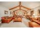 Open-concept living room with vaulted ceilings, wooden beams, and comfortable seating at 206 Somerville Rd, Anderson, IN 46011