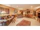 Cozy living room with comfortable leather seating, patterned rugs, and wood-paneled walls at 206 Somerville Rd, Anderson, IN 46011