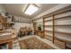 Versatile workshop space with ample shelving, a workbench, and natural light at 206 Somerville Rd, Anderson, IN 46011