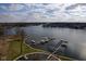 Aerial view of lakefront community with boat docks and well-maintained grounds at 20971 Shoreline Ct # 214, Noblesville, IN 46062