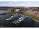 Aerial view of a brick apartment building overlooking a lake with boat docks at 20971 Shoreline Ct # 214, Noblesville, IN 46062