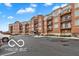 Brick apartment building with parking and balconies viewed on a sunny day at 20971 Shoreline Ct # 214, Noblesville, IN 46062