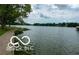 A stunning waterfront view with lush greenery along the shoreline on a cloudy day at 20971 Shoreline Ct # 214, Noblesville, IN 46062
