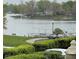 Scenic lake view with lush landscaping and covered boat docks near community at 20971 Shoreline Ct # 214, Noblesville, IN 46062