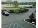 View of community parking lot with landscaping, parking spaces, and lake in background at 20971 Shoreline Ct # 214, Noblesville, IN 46062