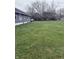Large backyard with trees and grassy area, perfect for outdoor activities and relaxation at 2124 W 64Th St, Indianapolis, IN 46260