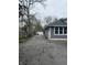 Wide driveway leading to a detached garage and backyard at 2124 W 64Th St, Indianapolis, IN 46260
