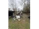 Cluttered backyard filled with discarded items and debris in a state of disrepair at 2124 W 64Th St, Indianapolis, IN 46260