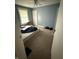 Bedroom with neutral walls and carpet flooring, featuring a window and ceiling fan at 2124 W 64Th St, Indianapolis, IN 46260