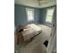 Bedroom with natural light from two windows and a ceiling fan at 2124 W 64Th St, Indianapolis, IN 46260