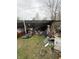 Dilapidated shed filled with refuse requires demolition or complete rebuild on an overgrown lawn at 2124 W 64Th St, Indianapolis, IN 46260