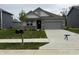 Charming single-story home with a two-car garage, manicured lawn, and a welcoming front entrance at 2199 Warbler St, Danville, IN 46122