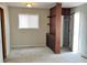 Bedroom with neutral walls, soft carpet, and built-in shelving and cabinets at 2260 N Graham Ave, Indianapolis, IN 46218