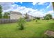 Wide backyard featuring a lush lawn and a wooden fence line at 2390 Lakecrest Dr, Columbus, IN 47201