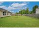Lush backyard featuring a well-manicured lawn, privacy fence, and mature trees at 2390 Lakecrest Dr, Columbus, IN 47201