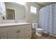 Bathroom featuring modern vanity with granite counter top, white cabinetry, and a shower/tub combo at 2390 Lakecrest Dr, Columbus, IN 47201