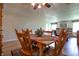 Comfortable dining room featuring a wooden table and chairs, a ceiling fan, and wood-look vinyl flooring at 2390 Lakecrest Dr, Columbus, IN 47201