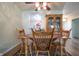 Inviting dining area with wooden table and chairs, a ceiling fan, and a china cabinet at 2390 Lakecrest Dr, Columbus, IN 47201