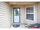 Front porch with decorative storm door, small window, and greenery near entrance at 2390 Lakecrest Dr, Columbus, IN 47201