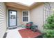 Cozy porch with seating, decorative trellis, and manicured plants at front entrance at 2390 Lakecrest Dr, Columbus, IN 47201