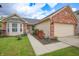 Attractive home featuring a well-maintained lawn, blooming roses, and a two-car garage at 2390 Lakecrest Dr, Columbus, IN 47201