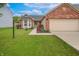 Inviting home with a well-kept lawn, red rose bushes, and an attached two-car garage at 2390 Lakecrest Dr, Columbus, IN 47201