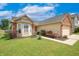 Charming home boasts a well-manicured lawn, brick accents, and a two-car garage at 2390 Lakecrest Dr, Columbus, IN 47201