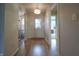 Bright hallway with wood floors, a decorative light fixture, and doorways at 2390 Lakecrest Dr, Columbus, IN 47201