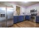 Kitchen with modern stainless steel appliances and sleek blue and white cabinets at 2390 Lakecrest Dr, Columbus, IN 47201