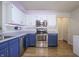 Kitchen showcasing stainless steel appliances, two-tone cabinets, recessed lighting, and wood-look vinyl flooring at 2390 Lakecrest Dr, Columbus, IN 47201