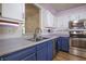 Well-lit kitchen showcases stainless steel appliances, stylish cabinetry, and wood flooring at 2390 Lakecrest Dr, Columbus, IN 47201