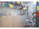 Functional laundry area with white washer and dryer and storage shelves at 2390 Lakecrest Dr, Columbus, IN 47201