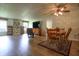 Open-concept living room featuring wood floors, built-in shelving, television and a dining area with a ceiling fan at 2390 Lakecrest Dr, Columbus, IN 47201