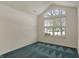 A bedroom has a vaulted ceiling with a large window overlooking the yard at 2755 Rylee Ct, Greenwood, IN 46143