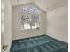 A bedroom has a vaulted ceiling with a large window overlooking the yard at 2755 Rylee Ct, Greenwood, IN 46143