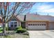 Charming brick home with an attached garage, manicured landscaping, and mature tree at 2755 Rylee Ct, Greenwood, IN 46143