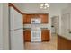 The kitchen features wood cabinets and white appliances, seamlessly connected to the laundry area at 2755 Rylee Ct, Greenwood, IN 46143