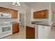 A well-appointed kitchen features white appliances, wood cabinets, and easy access to the laundry room at 2755 Rylee Ct, Greenwood, IN 46143