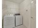 Well-lit laundry room with a washer, dryer, and overhead storage for convenience at 2755 Rylee Ct, Greenwood, IN 46143