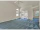 Bright living room with high ceilings, a ceiling fan, and a connecting view into another room at 2755 Rylee Ct, Greenwood, IN 46143